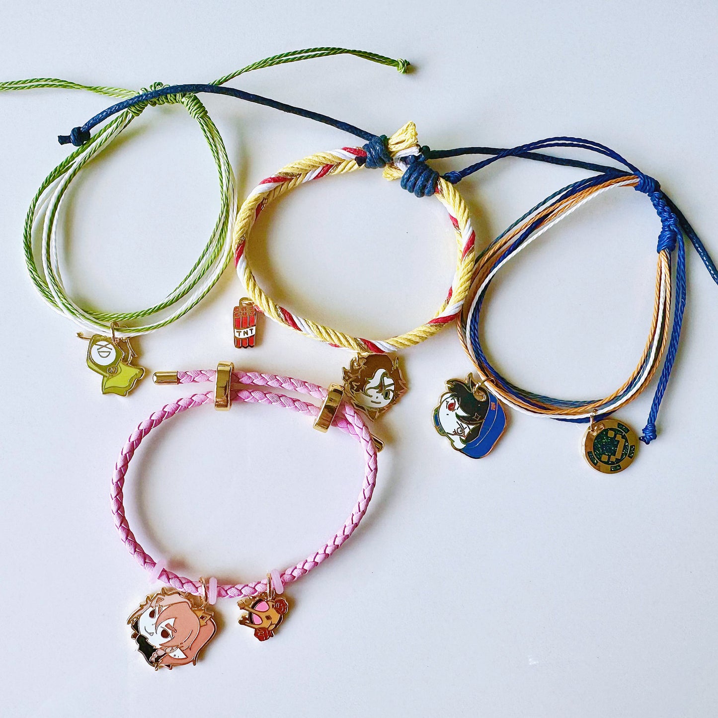 Colorful bracelets with charms on a white background