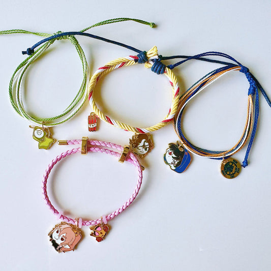 Colorful bracelets with charms on a white background
